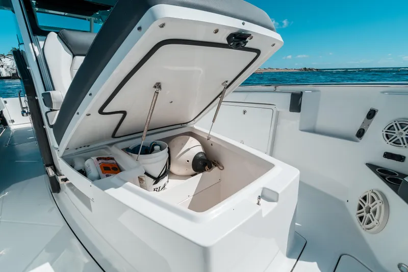  Yacht Photos Pics 2020 Blackfin 332 CC boat storage compartment open, revealing supplies and equipment.