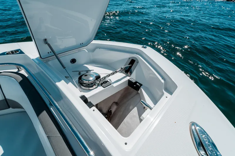  Yacht Photos Pics 2020 Blackfin 332 CC boat anchor compartment open on sparkling blue water.