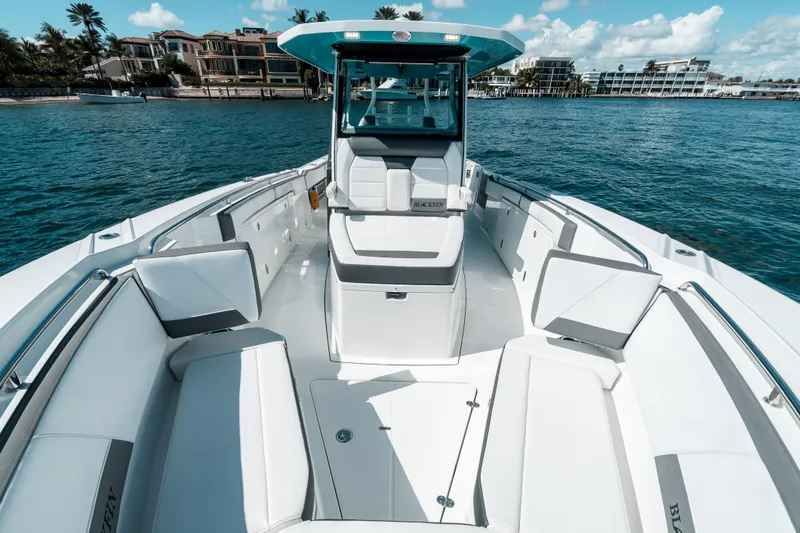  Yacht Photos Pics 2020 Blackfin 332 CC boat interior with luxurious seating on calm water.