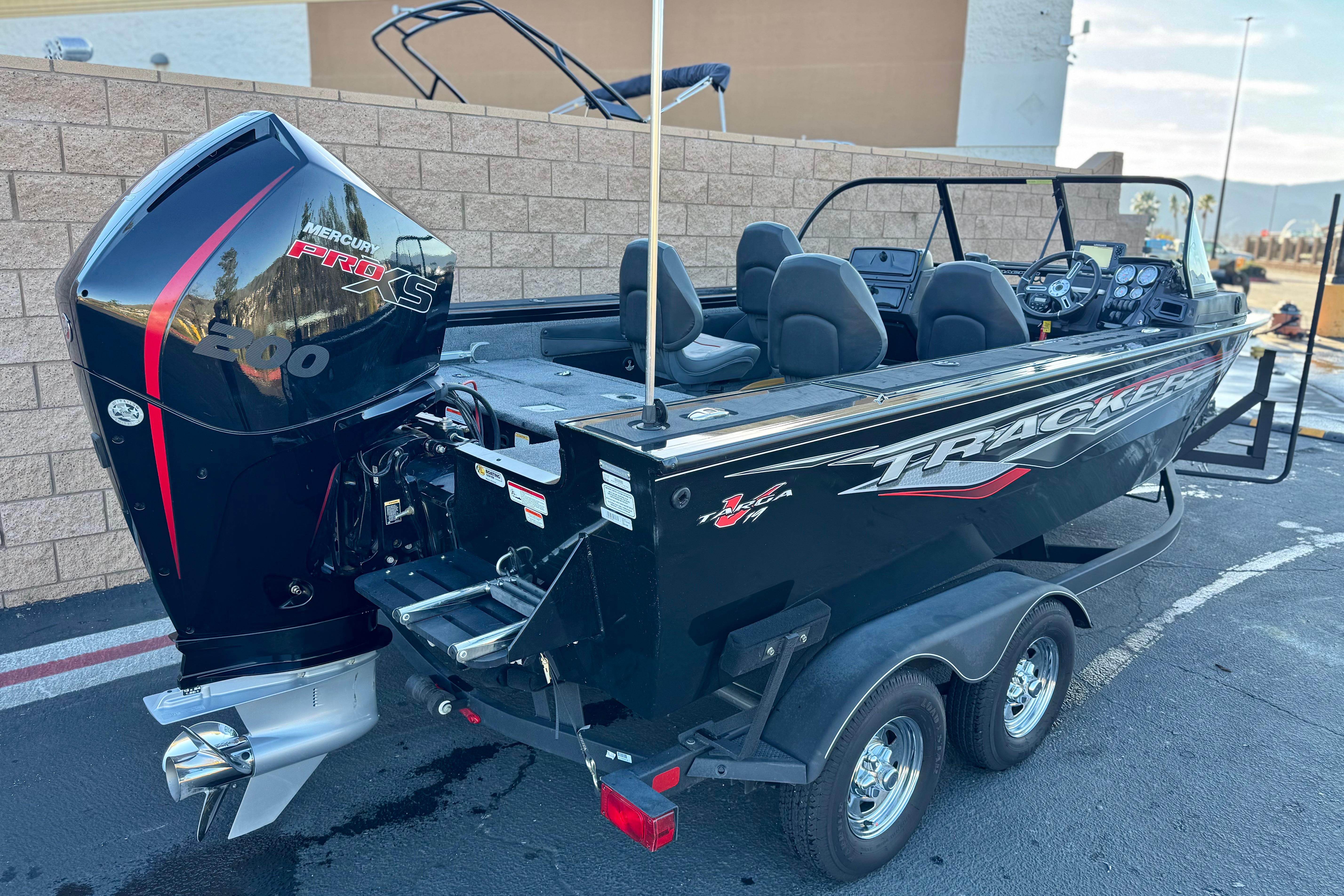 2023 Tracker Targa V-19 WT boat with Mercury Pro XS 200 engine, parked on trailer.