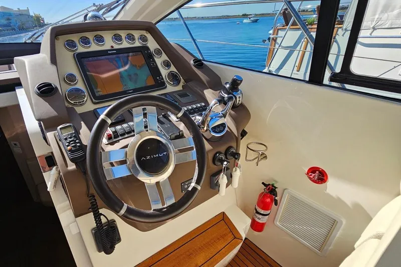  Yacht Photos Pics Helm of 2015 Azimut Atlantis 50 yacht with navigation controls and steering wheel.