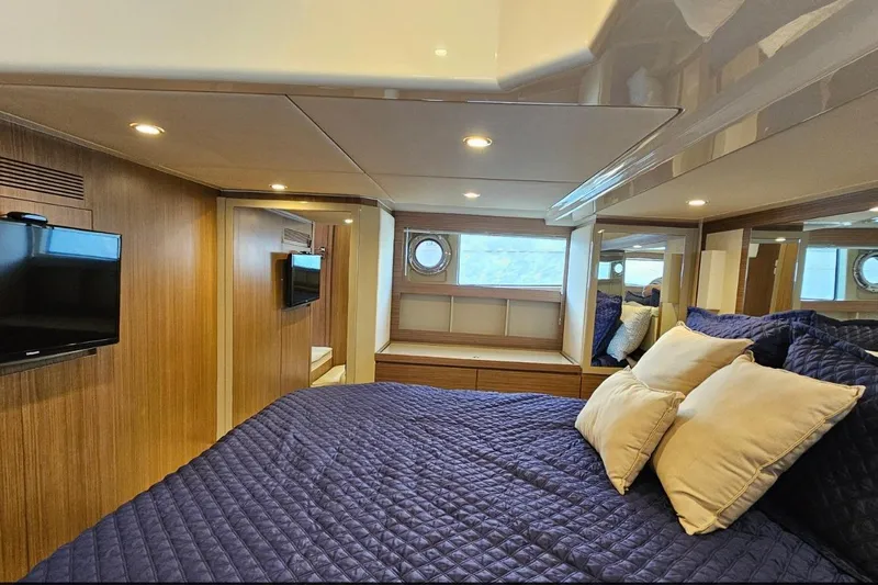  Yacht Photos Pics Luxurious bedroom interior of 2015 Azimut Atlantis 50 yacht with cozy bedding and modern decor.