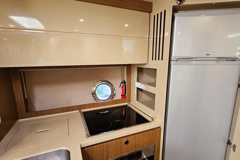  Yacht Photos Pics Modern kitchen interior of 2015 Azimut Atlantis 50 yacht with stove and fridge.