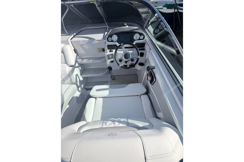 Yacht Photos Pics 2019 Regal 28 Express boat interior with steering wheel and seating.
