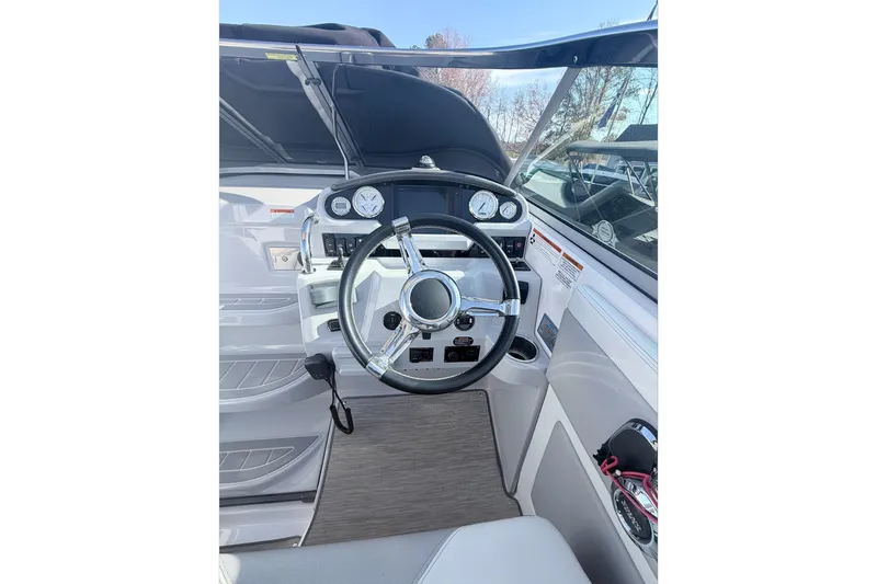  Yacht Photos Pics 2019 Regal 28 Express boat cockpit with steering wheel and dashboard controls.