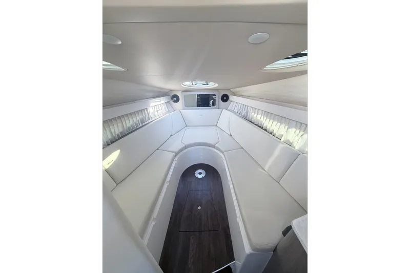  Yacht Photos Pics 2019 Regal 28 Express boat interior with white seating and wood flooring.