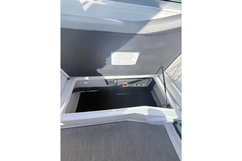  Yacht Photos Pics Open storage compartment on 2019 Regal 28 Express boat, showcasing interior details.