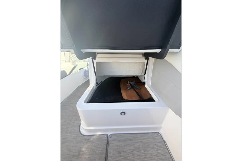  Yacht Photos Pics 2019 Regal 28 Express boat storage compartment with open lid and interior view.