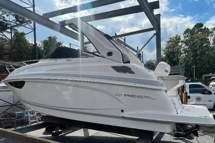  Yacht Photos Pics 2019 Regal 28 Express boat on a trailer in a marina setting under a blue sky.