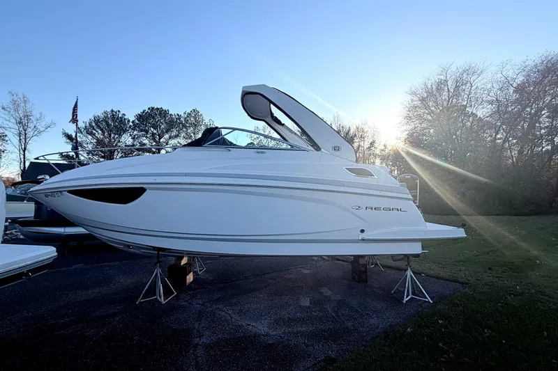  Yacht Photos Pics 2019 Regal 28 Express boat on stands, sunlit background, parked outdoors.