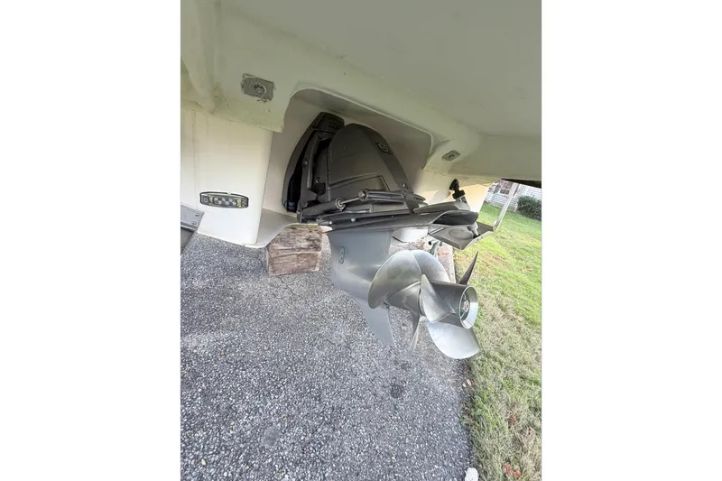  Yacht Photos Pics 2019 Regal 28 Express boat propeller and stern drive on gravel surface.