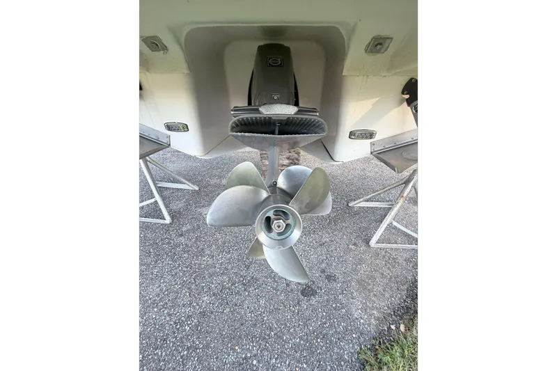  Yacht Photos Pics 2019 Regal 28 Express boat propeller and stern view on gravel surface.