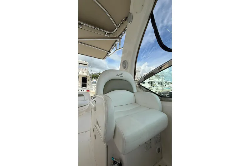  Yacht Photos Pics Captain's seat on 2006 Sea Ray 340 Sundancer yacht, under canopy, with marina view.