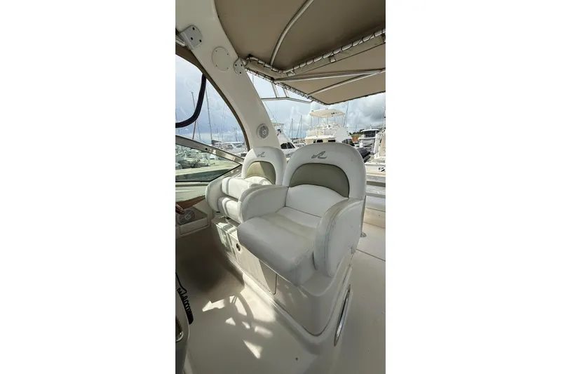  Yacht Photos Pics 2006 Sea Ray 340 Sundancer cockpit with plush seating and marina view.