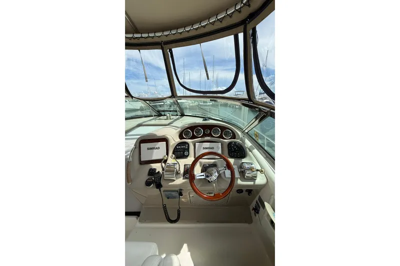  Yacht Photos Pics 2006 Sea Ray 340 Sundancer helm with Simrad navigation system and wooden steering wheel.