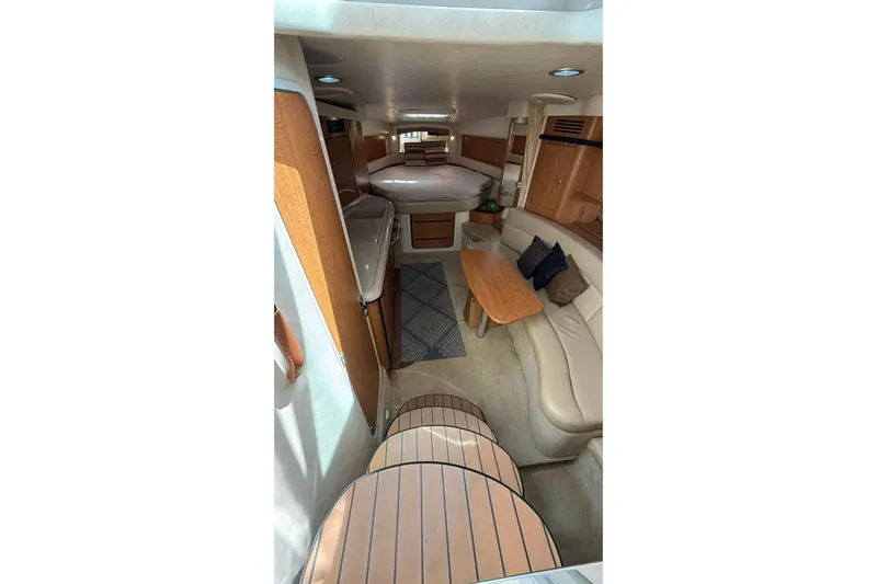  Yacht Photos Pics Interior of 2006 Sea Ray 340 Sundancer yacht with cozy seating and wooden accents.