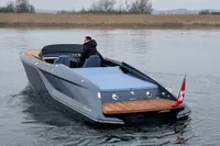 2024 Frauscher 858 Fantom luxury boat on calm water, rear view with sleek design.