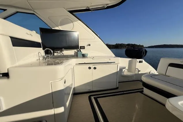  Yacht Photos Pics Luxurious 2010 Sea Ray 450 Sundancer yacht interior with kitchenette and scenic water view.