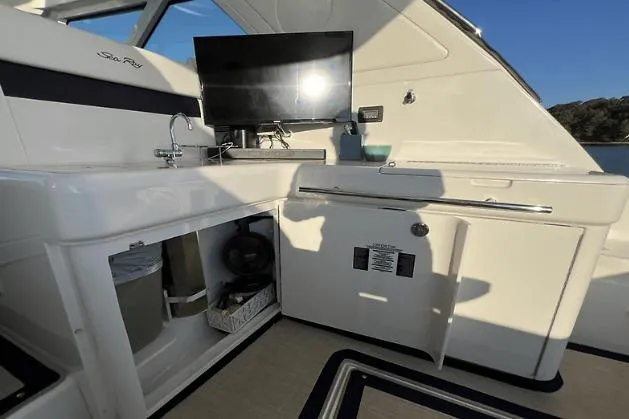  Yacht Photos Pics 2010 Sea Ray 450 Sundancer yacht interior with kitchenette and TV setup.