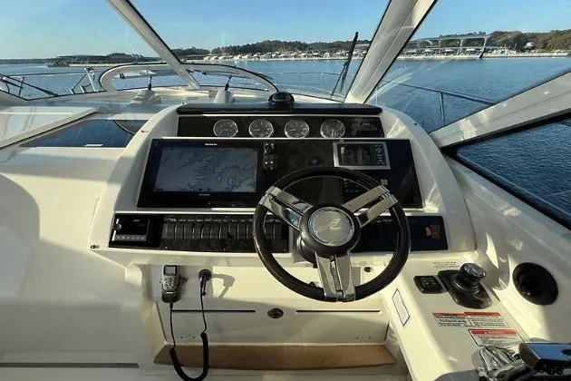  Yacht Photos Pics Cockpit view of 2010 Sea Ray 450 Sundancer yacht with steering wheel and navigation system.