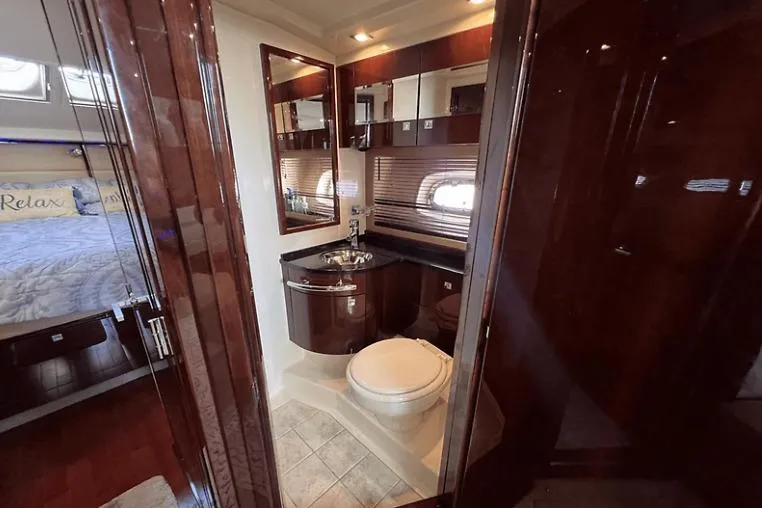  Yacht Photos Pics Luxurious bathroom interior of 2010 Sea Ray 450 Sundancer yacht, featuring elegant wood finishes.