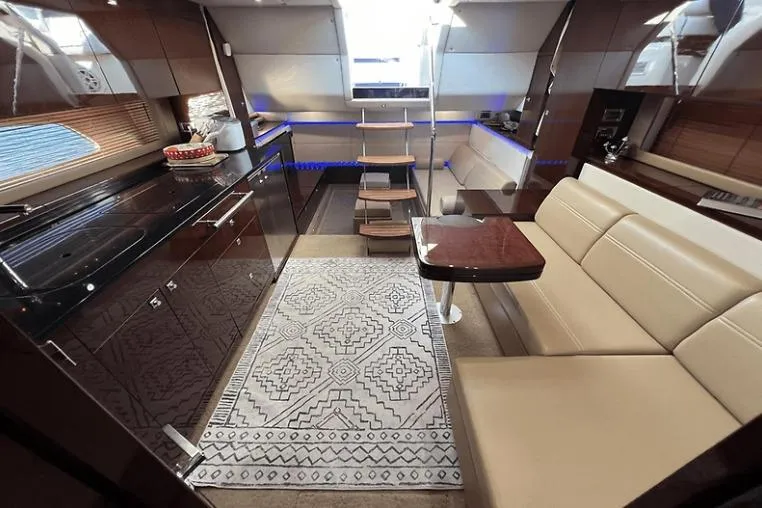  Yacht Photos Pics Luxurious interior of a 2010 Sea Ray 450 Sundancer yacht with modern kitchen and seating area.