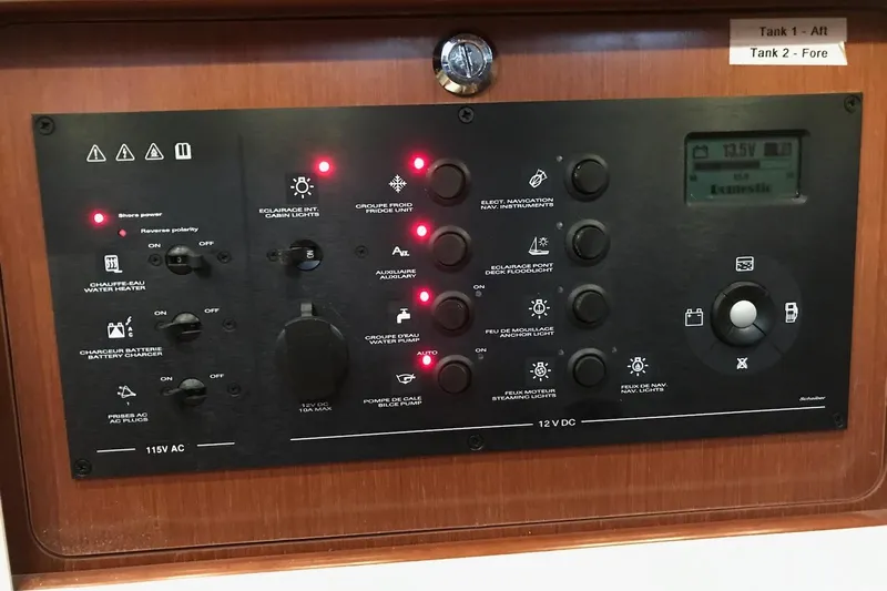 At Last Yacht Photos Pics Control panel of a 2012 Beneteau Oceanis 45 yacht, featuring various switches and indicators.