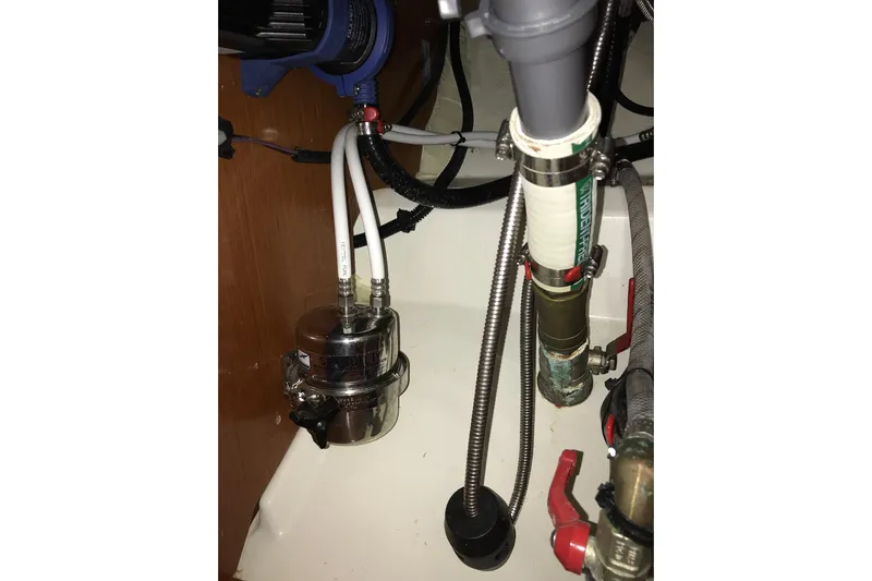 At Last Yacht Photos Pics Plumbing system inside a 2012 Beneteau Oceanis 45 yacht, featuring pipes and valves.