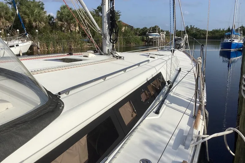 At Last Yacht Photos Pics 2012 Beneteau Oceanis 45 sailboat docked in a serene marina setting.