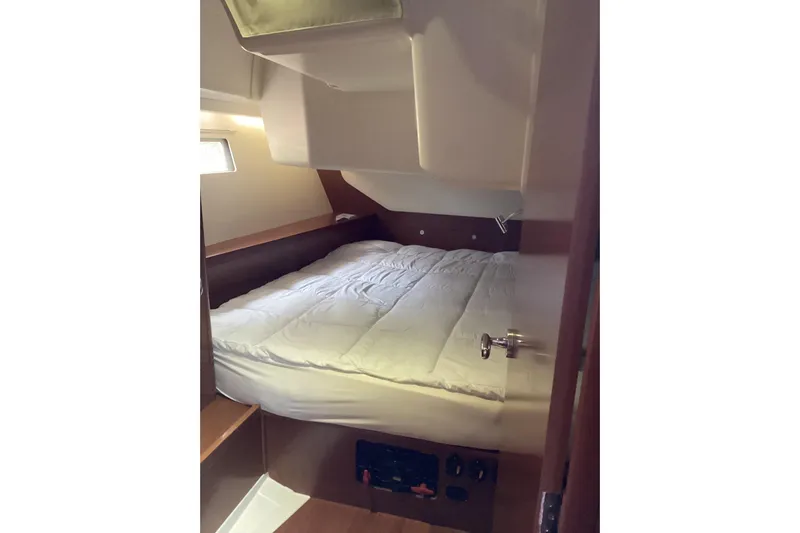 At Last Yacht Photos Pics Cozy cabin interior of 2012 Beneteau Oceanis 45 sailboat with comfortable bedding.