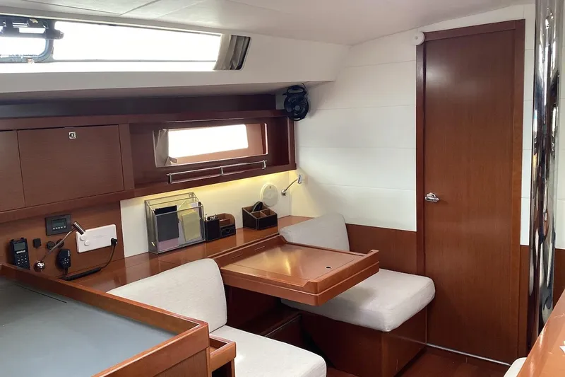 At Last Yacht Photos Pics Interior of 2012 Beneteau Oceanis 45 yacht with wooden furnishings and seating area.