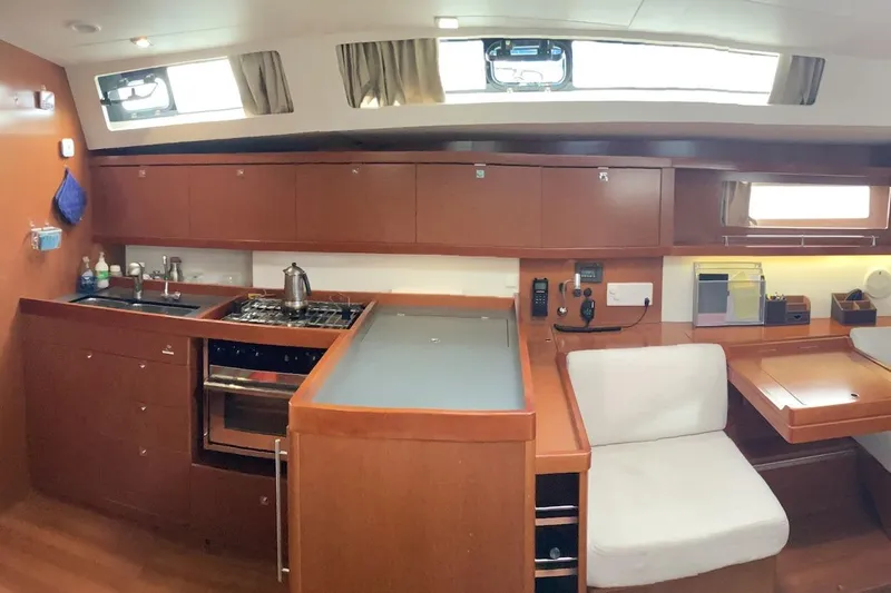 At Last Yacht Photos Pics Interior of 2012 Beneteau Oceanis 45 yacht, featuring a modern kitchen and seating area.