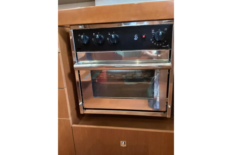 At Last Yacht Photos Pics Built-in oven on 2012 Beneteau Oceanis 45 yacht, featuring stainless steel finish and control knobs.