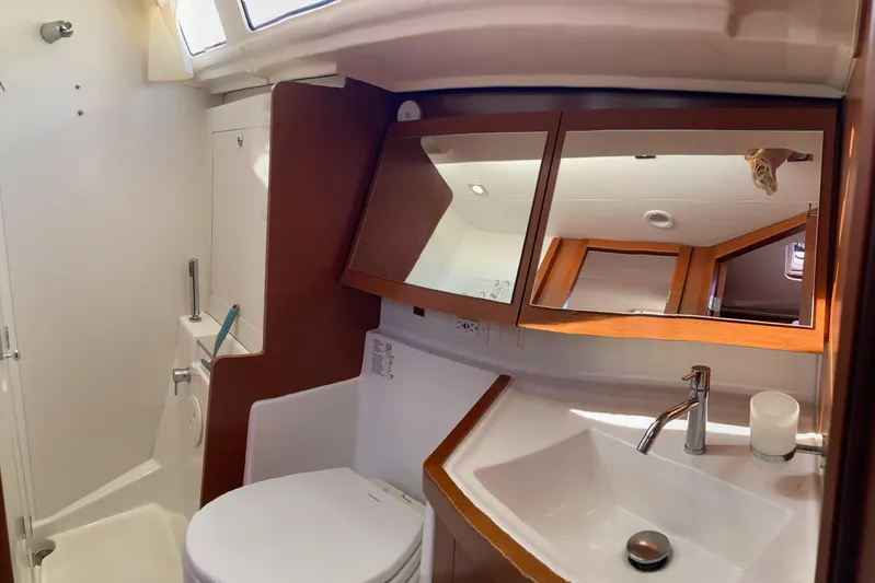 At Last Yacht Photos Pics Bathroom interior of 2012 Beneteau Oceanis 45 yacht, featuring sink, mirror, and shower.