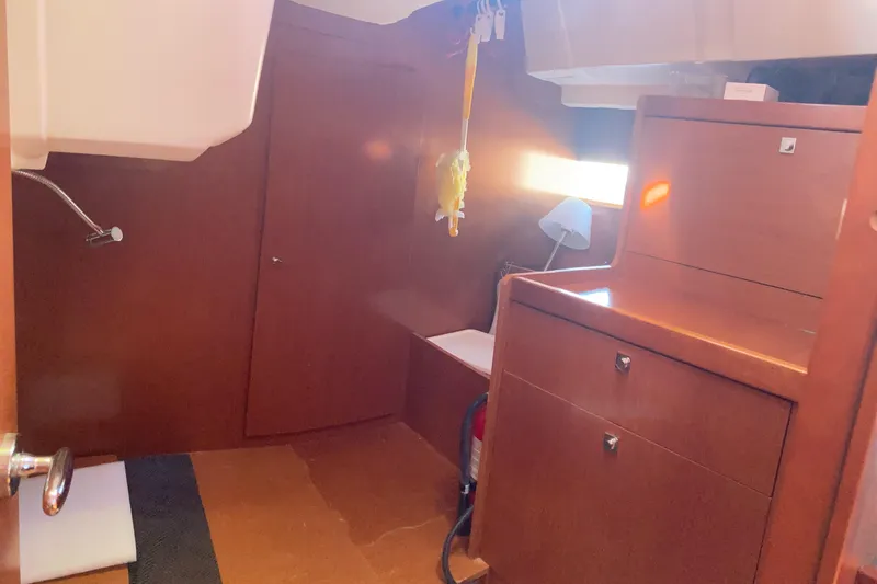 At Last Yacht Photos Pics Interior of 2012 Beneteau Oceanis 45 yacht, featuring wooden cabinetry and a cozy layout.