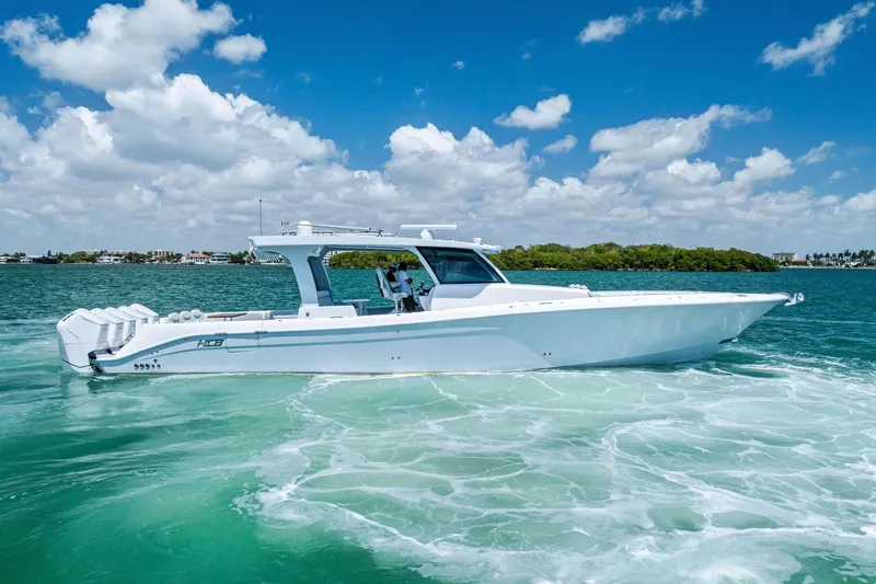  Yacht Photos Pics 2025 HCB 56 Suenos GIX luxury boat cruising on clear blue water.