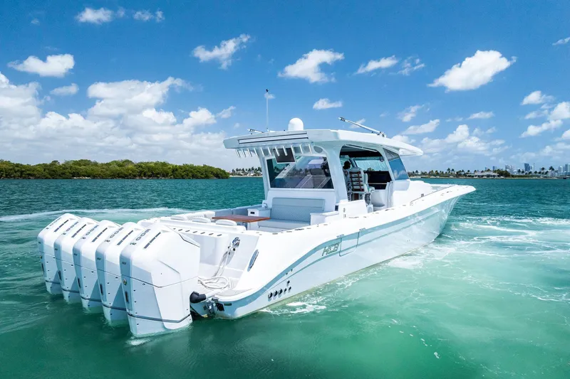  Yacht Photos Pics 2025 HCB 56 Suenos GIX luxury boat cruising on clear blue water.