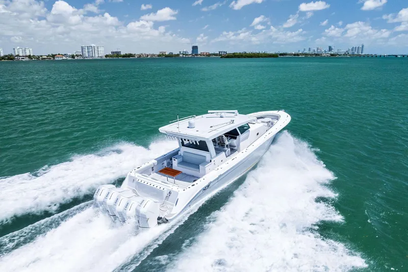  Yacht Photos Pics 2025 HCB 56 Suenos GIX cruising on turquoise waters under a clear sky.