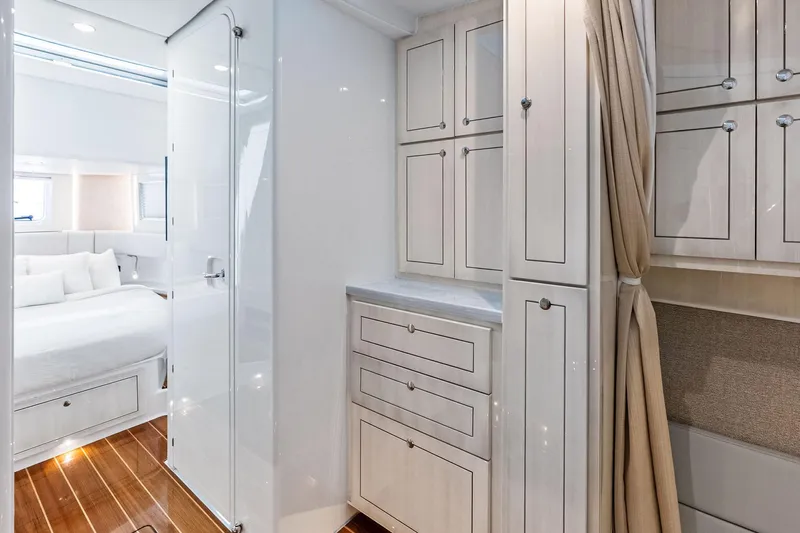  Yacht Photos Pics Luxurious interior of 2025 HCB 56 Suenos GIX yacht with elegant cabinetry and cozy bedroom.