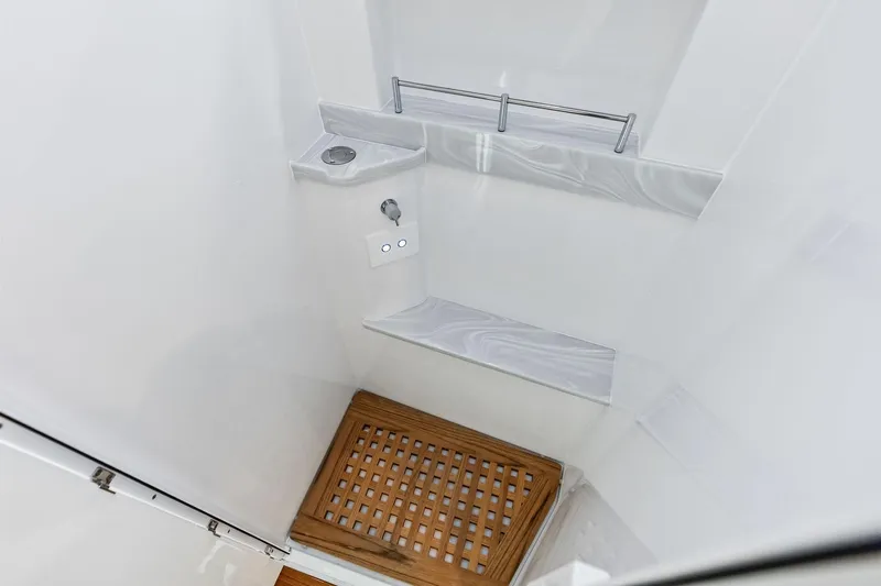  Yacht Photos Pics 2025 HCB 56 Suenos GIX shower with wooden floor and modern fixtures.