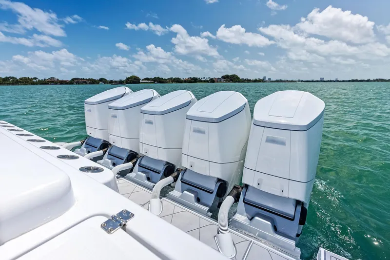  Yacht Photos Pics Four powerful outboard engines on a 2025 HCB 56 Suenos GIX boat in clear waters.