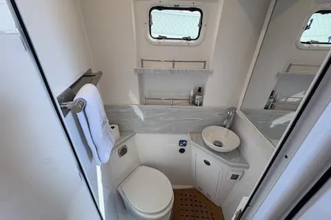  Yacht Photos Pics 2025 HCB 56 Suenos GIX yacht bathroom with modern fixtures and compact design.