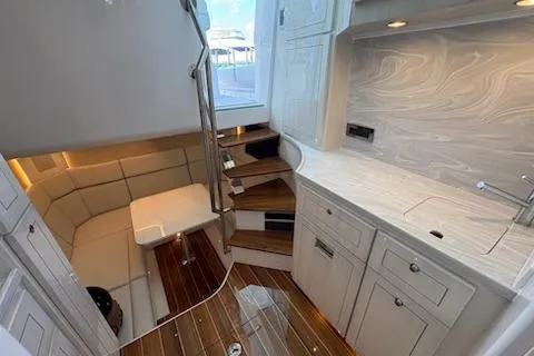  Yacht Photos Pics Luxurious interior of 2025 HCB 56 Suenos GIX yacht with modern kitchen and seating area.