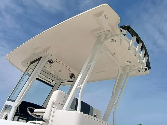 270-152 Yacht Photos Pics 2025 Robalo R270 Center Console boat, featuring a sleek T-top design against a clear blue sky.