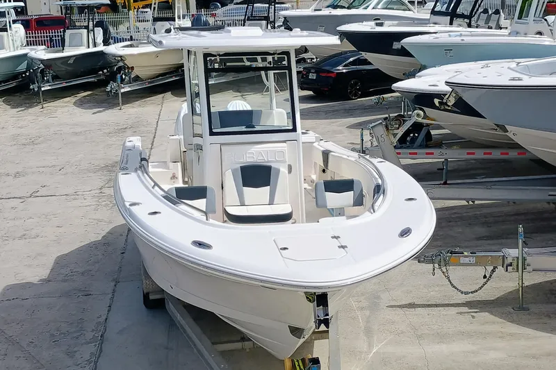 270-152 Yacht Photos Pics 2025 Robalo R270 Center Console boat on trailer in marina setting.