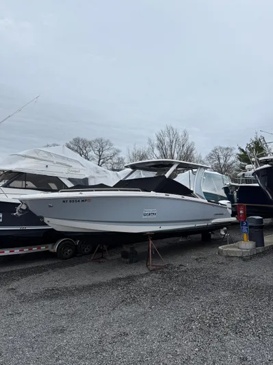  Yacht Photos Pics 2020 Chaparral 300 OSX boat on trailer in outdoor storage area.