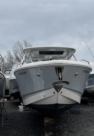  Yacht Photos Pics 2020 Chaparral 300 OSX boat on display, front view, overcast sky background.