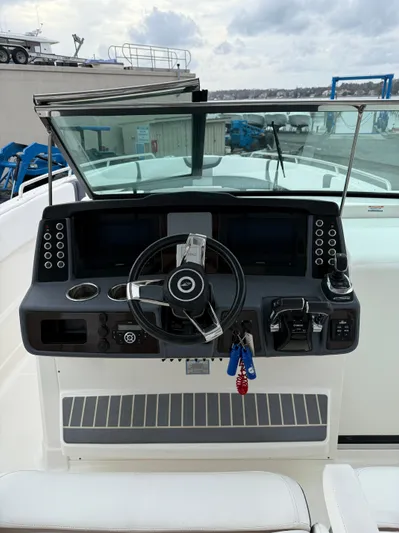  Yacht Photos Pics 2020 Chaparral 300 OSX boat dashboard with steering wheel and controls.