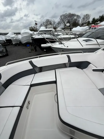  Yacht Photos Pics 2020 Chaparral 300 OSX boat interior with sleek seating, docked among other boats.