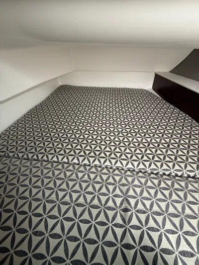  Yacht Photos Pics 2020 Chaparral 300 OSX cabin interior with geometric-patterned bedding.